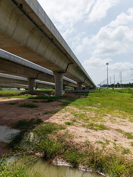 istock Highway interchange crossing over green farmlands in Thailand 2225375497