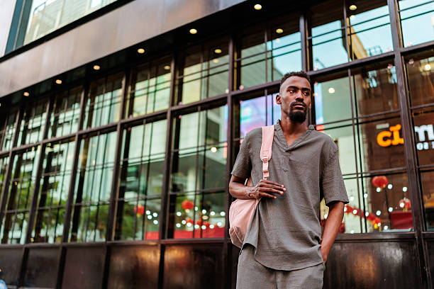 istock Confident man by a building reflecting Bangkok's Chainatown lights 2225376143