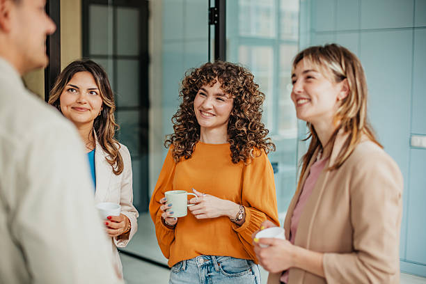istock Team members engage in a collaborative discussion while enjoying coffee in a modern office setting 2225376411