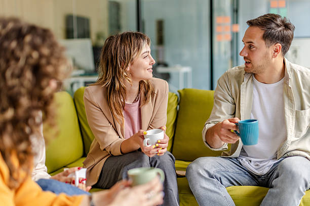 istock Team members engage in a collaborative discussion while enjoying coffee in a modern office setting 2225376471