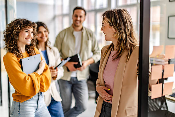 istock Team members engage in a lively discussion during a collaborative work meeting in a modern office environment 2225376544