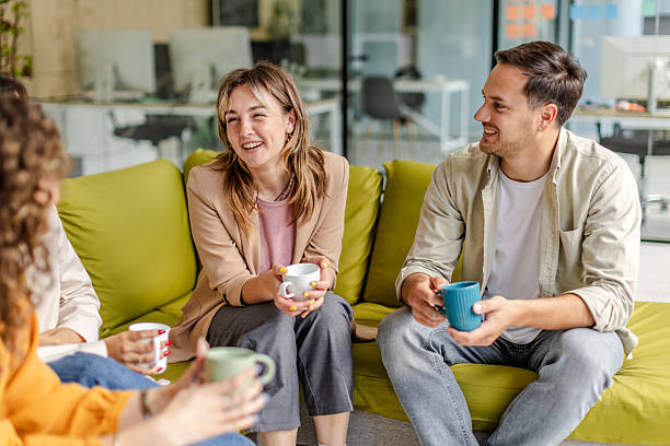 istock Team members engage in a lively discussion while enjoying coffee in a modern office setting 2225376580