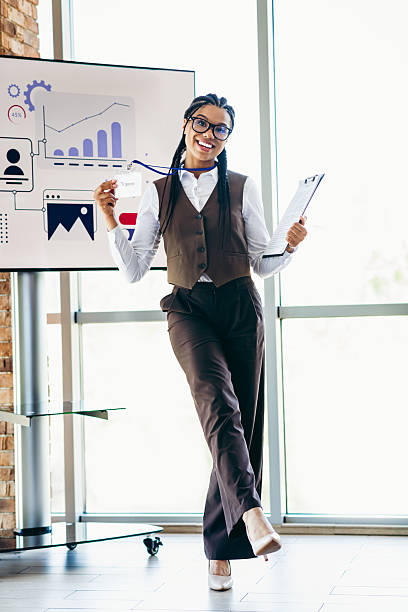 Confident Businesswoman Presenting Data in Office Setting with a Positive and Ambitious Attitude