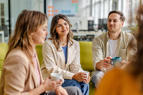 istock Team members engaged in a productive discussion during a casual meeting in a modern office setting 2225378725