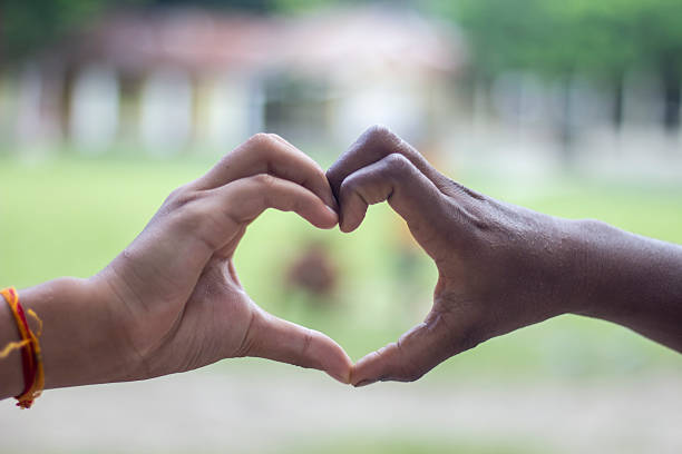 istock Two men make a love sign and a green background blur 2225378886
