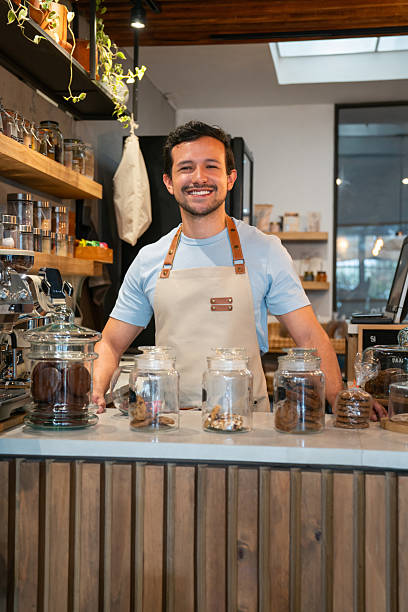 istock Happy barista working at a coffee shop 2225385004