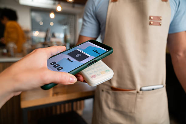 istock Close-up on a customer making a mobile payment at a cafe 2225385054