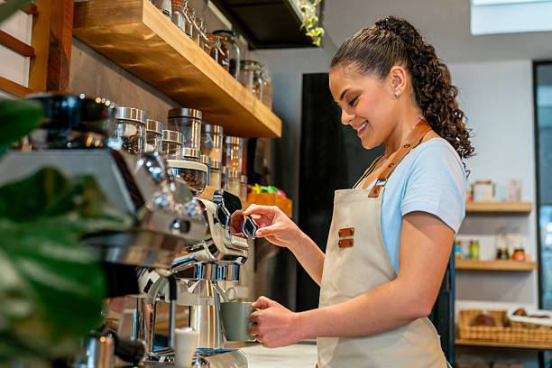 istock Happy barista making a cappuccino at a coffee shop 2225385146