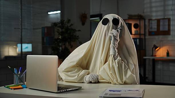 istock Ghost in Office with Laptop and Phone Costume Setup 2225385201