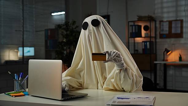 istock Ghostly Figure Holding a Credit Card in an Office Setting 2225385434