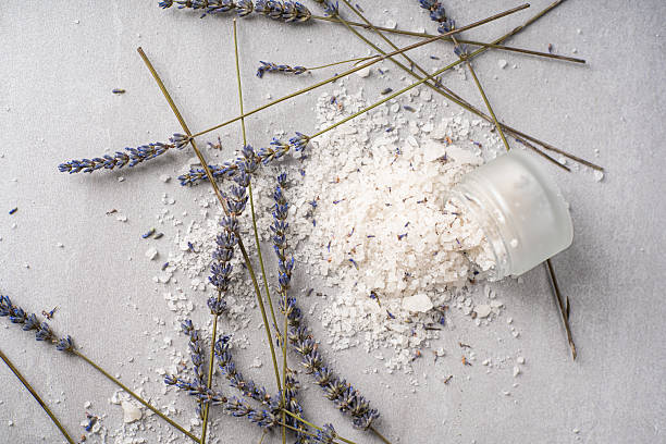 istock Lavender bath products and accessories arranged on a light background with scattered salt and a plant sprig 2225385816