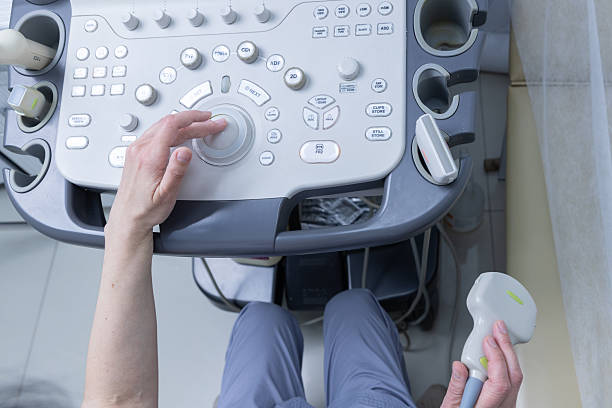 istock Operator Engaging with Advanced Ultrasonic Equipment for Medical Imaging Procedures in a Clinical Setting with Controls Displayed Prominently and Focus on User Interaction 2225386033