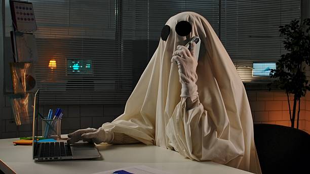 istock Mysterious Ghost Costume in an Office Setting at Nighttime 2225386628
