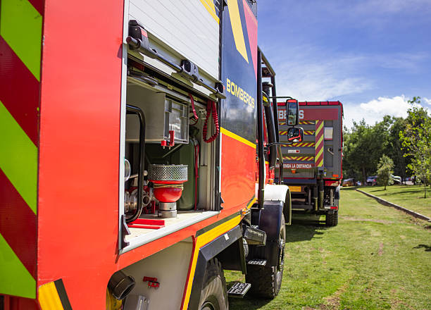 istock Modern fire truck parked on grass with open compartment showing equipment 2225387796