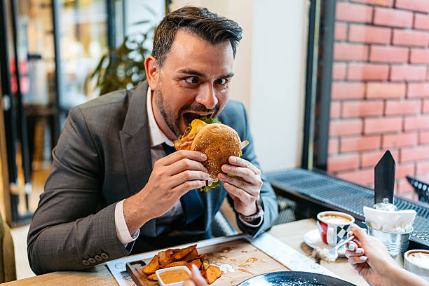 istock Funny Young Businessman Having Lunch In A Restaurant 2225387849