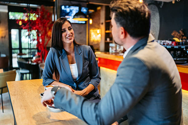istock Two Business Colleagues Drinking Coffee In A Coffee Shop 2225389217