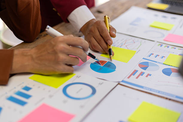 istock Businessman analyzing financial data with chart and graph. Business team collaborates in office, analyzing data, brainstorming ideas, and developing strategies for success. 2225390204
