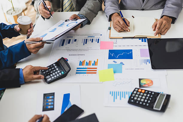 istock Financial advisor meeting and working with data using calculator and pointing at chart. Business professional collaborate, analyze financial data, and planning in a meeting. 2225390398