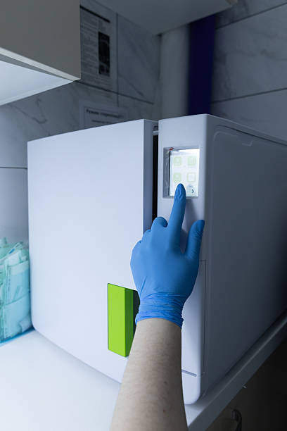 istock A Professional's Gloved Hand Interacting with a Medical Equipment Display: Emphasizing Hygiene and Technology in Clinical Settings 2225391429