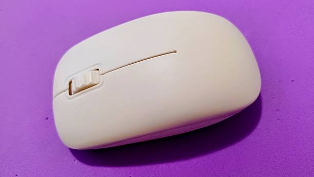 istock Close-up of a Computer Mouse on a purple background. 2225391946