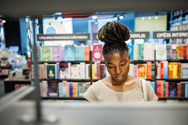 istock Young Lady Surrounded by Bookshelves 2225393866