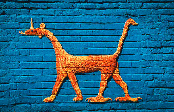 Vibrant orange mural of an ancient creature stands out against a blue wall in Babylon, Iraq, highlighting rich cultural history.