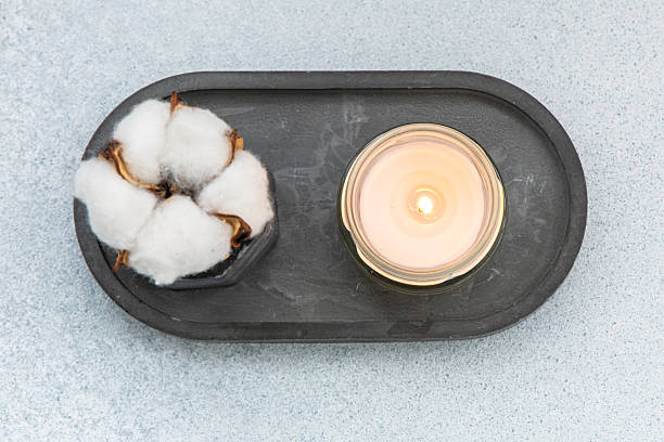 istock Candle and cotton decor arrangement on a gray background creating a cozy atmosphere 2225393894