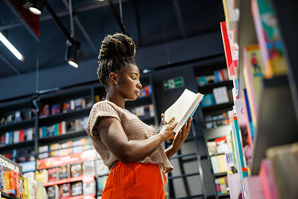 istock Young Lady Browsing Books in Bookstore 2225393965