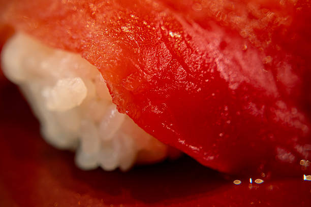 Close-up of freshly prepared nigiri sushi on a ceramic plate, served in a traditional Japanese restaurant setting