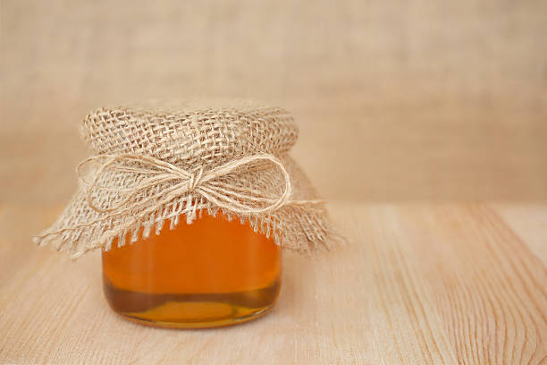 istock Bee honey on a wooden table 2225402148