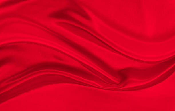 istock Black red satin dark fabric texture luxurious shiny that is abstract silk cloth background with patterns soft waves blur beautiful. 2225404589