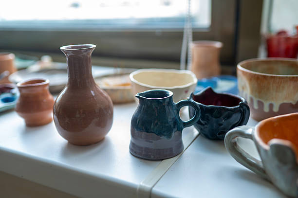 istock Colorful handmade ceramic vases and mugs on pottery table 2225408487