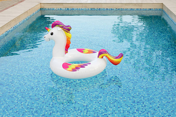 istock A cheerful inflatable unicorn float gently rests in a sparkling blue swimming pool, ready for summer enjoyment. 2225409317