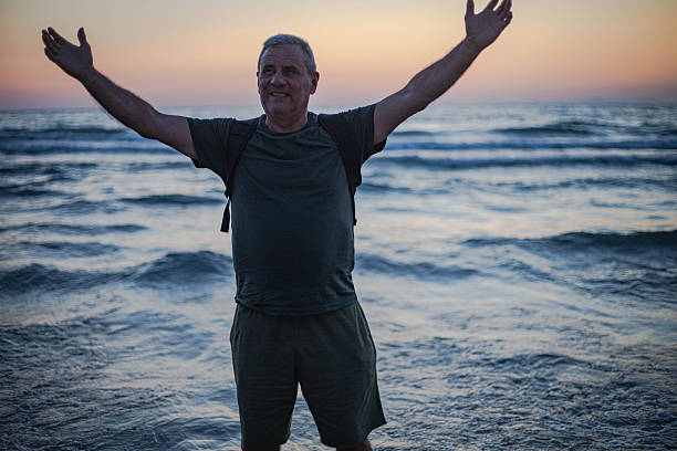 istock A man enjoys watching the sunset on the sea horizon 2225410338