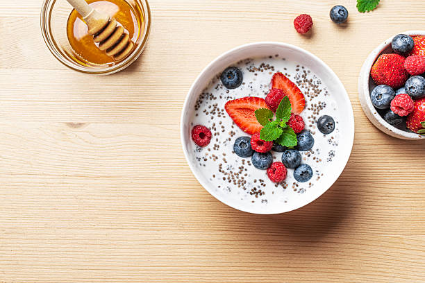 istock Chia bowl with yogurt, berries and honey on wooden table 2225410367