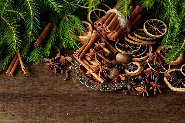istock Various Christmas spices with dried citrus slices on silver tray. 2225412739