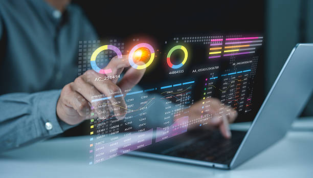 istock A person interacts with a transparent digital interface displaying colorful charts and data analytics above a laptop. 2225414789