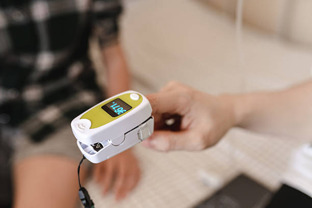 istock A hand is using a finger clip oximeter to measure 2225416066