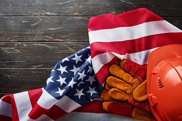 istock Happy Labor Day. Construction tools hammer, wrench, screwdriver, pliers, construction helmet on dark brutal old wooden background with scratches and copy space for text. Design element 2225420666