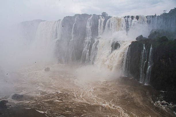 The magnificent Iguazu Falls cascading down, creating a powerful and misty landscape in South America, a breathtaking display of nature's raw beauty