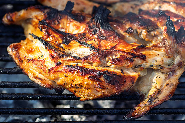 istock Pork chops, steak, sausages on barbecue grill with smoke 2225424436
