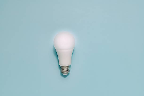 istock White LED Light Bulb on Muted Blue Background, Energy Saving Concept 2225427805