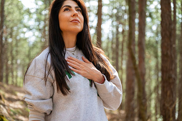 istock Relaxed woman breathing fresh air in a pine forest 2225428006