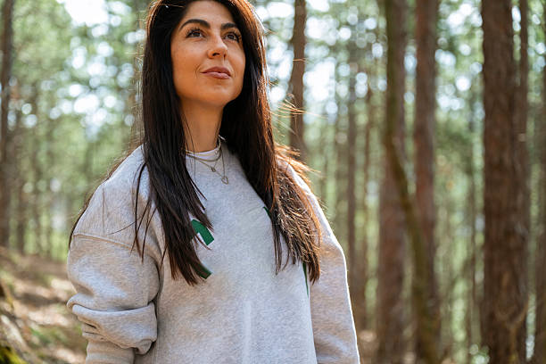 istock Relaxed woman breathing fresh air in a pine forest 2225428013