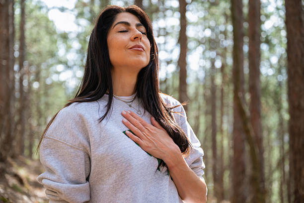istock Relaxed woman breathing fresh air in a pine forest 2225428014