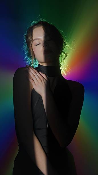 istock Woman in rainbow spotlight with dramatic contrast 2225428364
