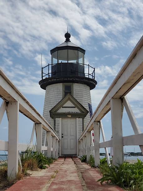 istock Historic Lighthouse with Boardwalk Entrance on a Sunny Day 2225434754