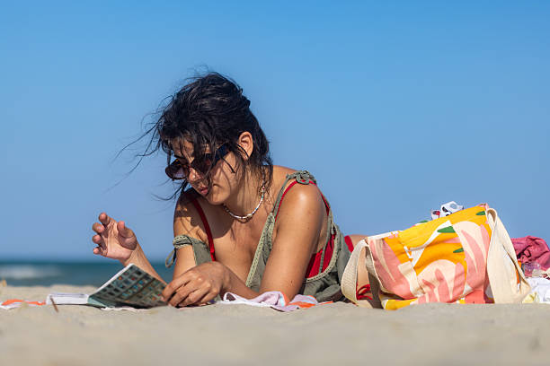 Girl reading book on the beach