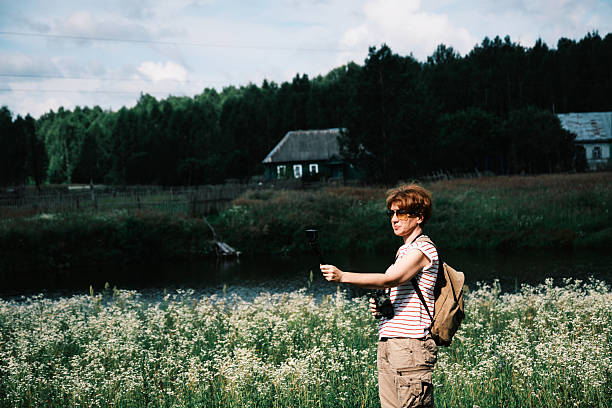 Female vlogger is exploring remote semi-abandoned village