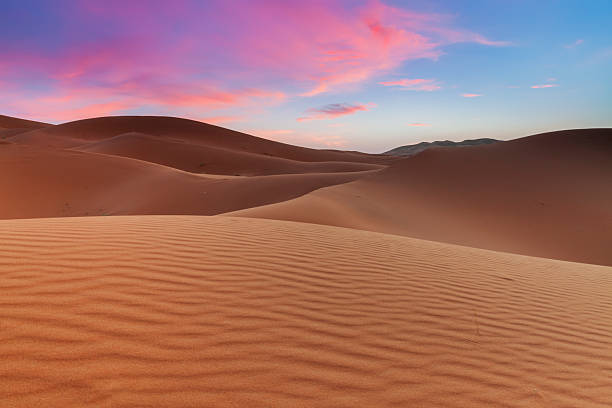 istock Sunrise over sand dunes, Western Sahara Desert in Morocco 2225442003
